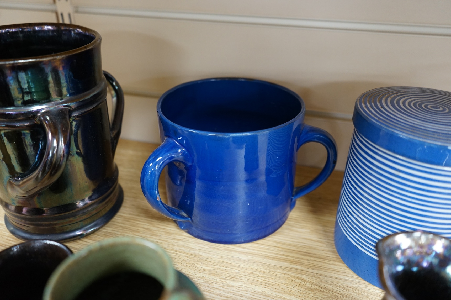 A collection of pottery to include lustre glazed jugs and tygs, a T. G. Green storage jar, Carltonware ash tray and a miniature Ruskin style vase, largest 18cm high